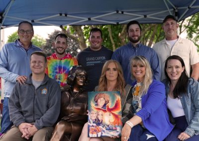 board members sitting with statue of cathy lee
